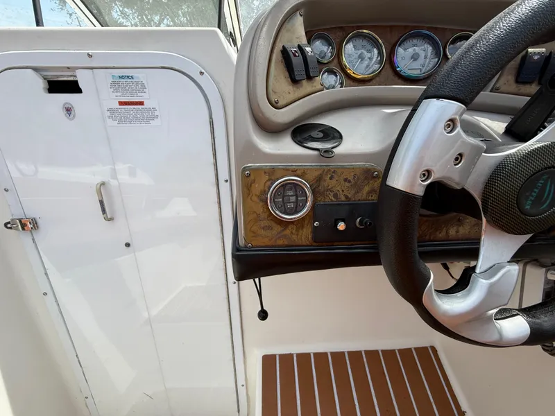 Slide: The Image of 2000 Wellcraft 2400 Martinique boat dashboard with steering wheel and instrument panel. - 40