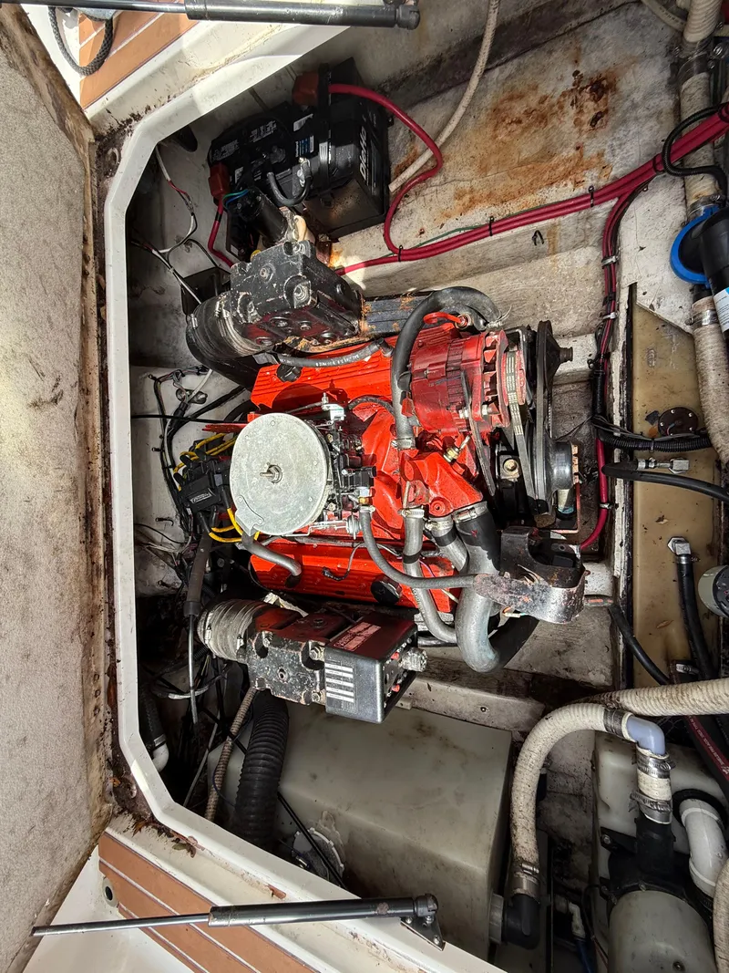 Slide: The Image of Engine compartment of a 2000 Wellcraft 2400 Martinique boat, featuring a red engine. - 43