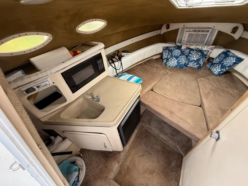 Slide: The Image of Interior of 2000 Wellcraft 2400 Martinique boat with kitchenette and cozy seating area. - 46