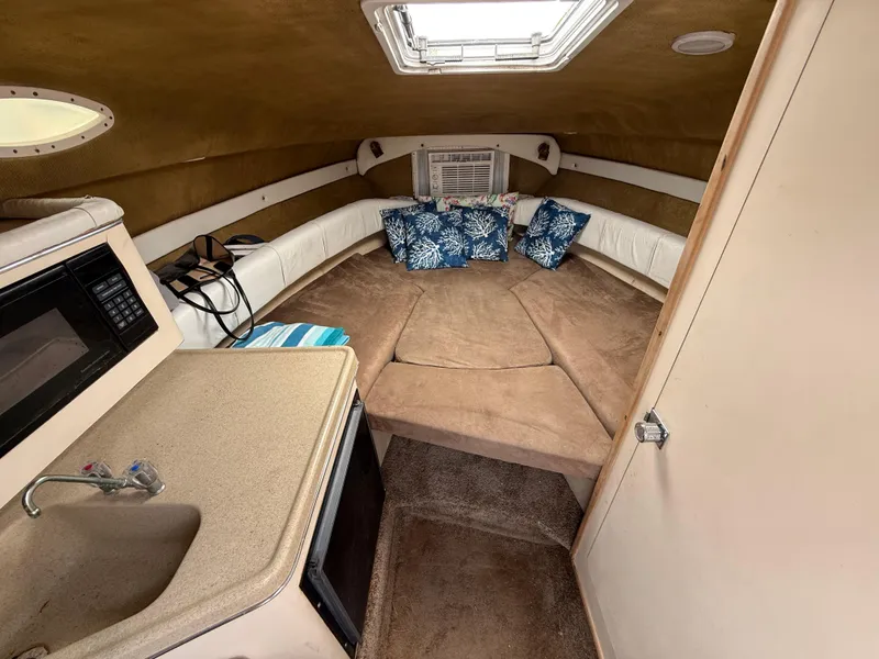 Slide: The Image of Interior of 2000 Wellcraft 2400 Martinique boat with cozy cabin and kitchenette. - 47