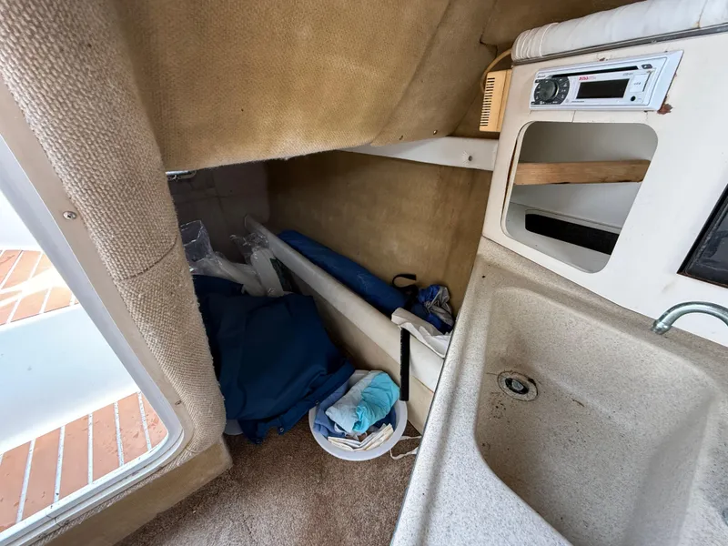 Slide: The Image of Interior cabin of 2000 Wellcraft 2400 Martinique boat with sink and storage. - 48