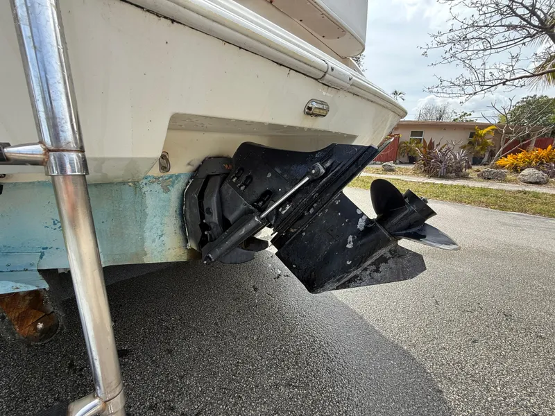 Slide: The Image of 2000 Wellcraft 2400 Martinique boat stern with outboard motor on pavement. - 6