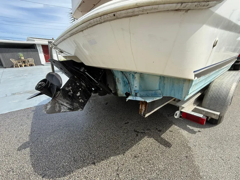 Slide: The Image of 2000 Wellcraft 2400 Martinique boat on trailer, showing stern and propeller. - 8