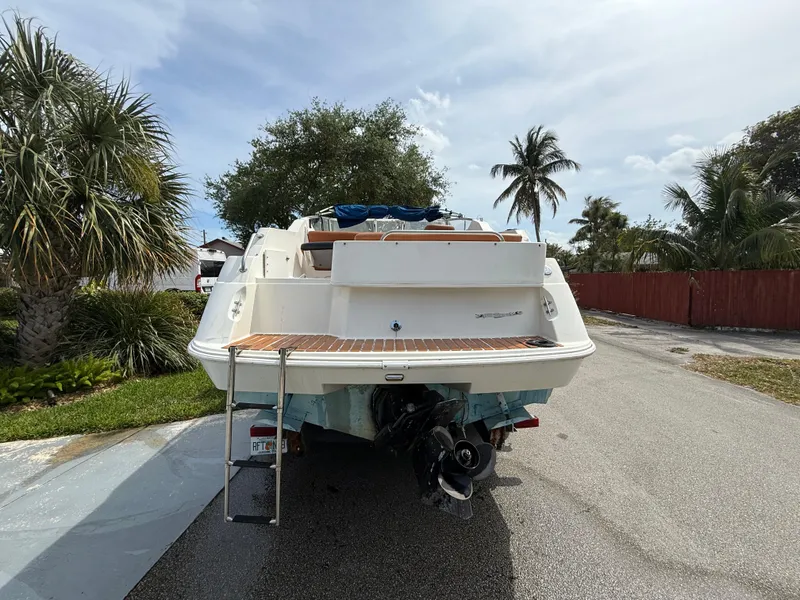 Slide: The Image of 2000 Wellcraft 2400 Martinique boat parked on a sunny street with palm trees. - 9