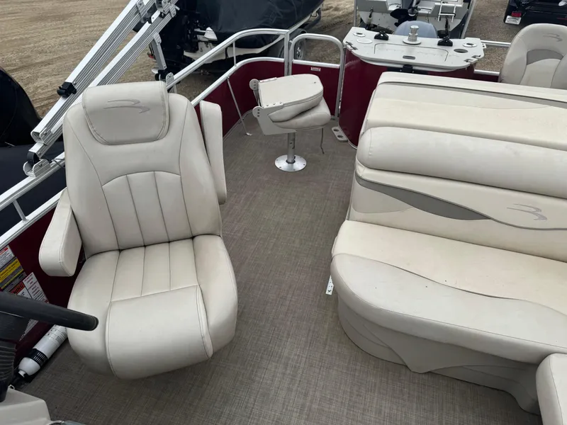 Slide: The Image of 2016 Bennington 22 SS boat interior with beige seating and steering console. - 10