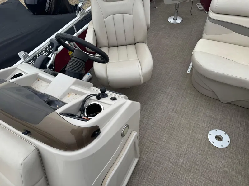 Slide: The Image of 2016 Bennington 22 SS boat interior with beige seating and steering console. - 11