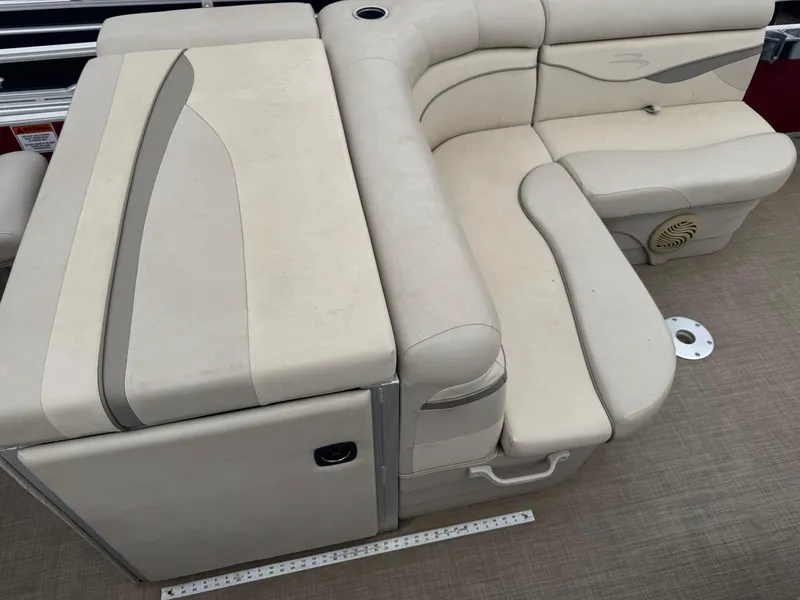 Slide: The Image of 2016 Bennington 22 SS boat seating with beige upholstery and integrated cup holder. - 6