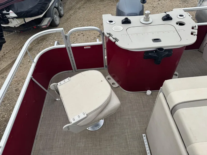 Slide: The Image of 2016 Bennington 22 SS pontoon boat interior with red paneling and beige seating. - 7