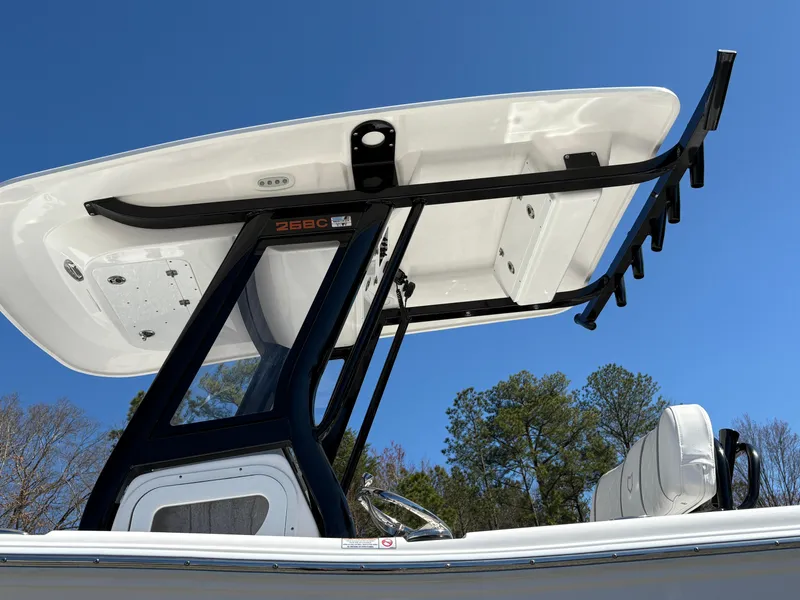 Slide: The Image of 2024 Sea Fox 268 Commander boat with T-top against clear blue sky. - 11