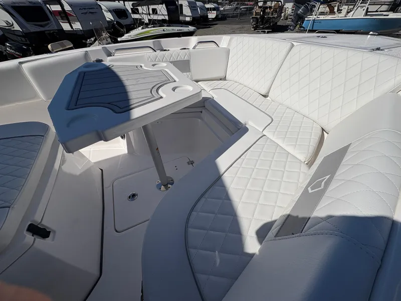 Slide: The Image of 2024 Sea Fox 268 Commander boat interior with white quilted seating and table. - 14