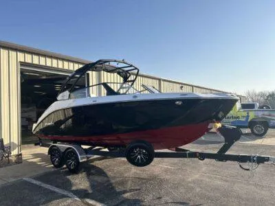 Slide: The Image of 2025 Yamaha Boats 222SD on trailer outside a warehouse, sunny day. - 3