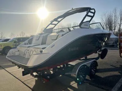 Slide: The Image of 2025 Yamaha Boats 222SD on trailer, sunlit, parked outdoors. - 4