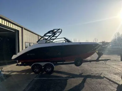 Slide: The Image of 2025 Yamaha Boats 222SD on trailer outside a warehouse in sunlight. - 5