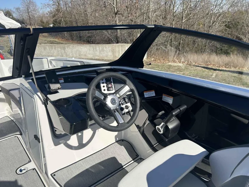 Slide: The Image of 2025 Yamaha Boats 222SD cockpit with modern steering and controls, outdoor setting. - 9