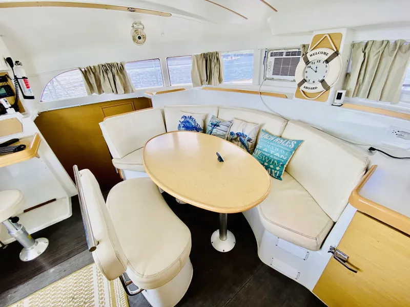 Slide: The Image of Interior of 2014 Lagoon 380 S2 catamaran with cozy seating and nautical decor. - 19