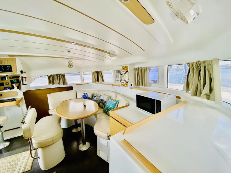 Slide: The Image of Interior of 2014 Lagoon 380 S2 catamaran with modern seating and dining area. - 20