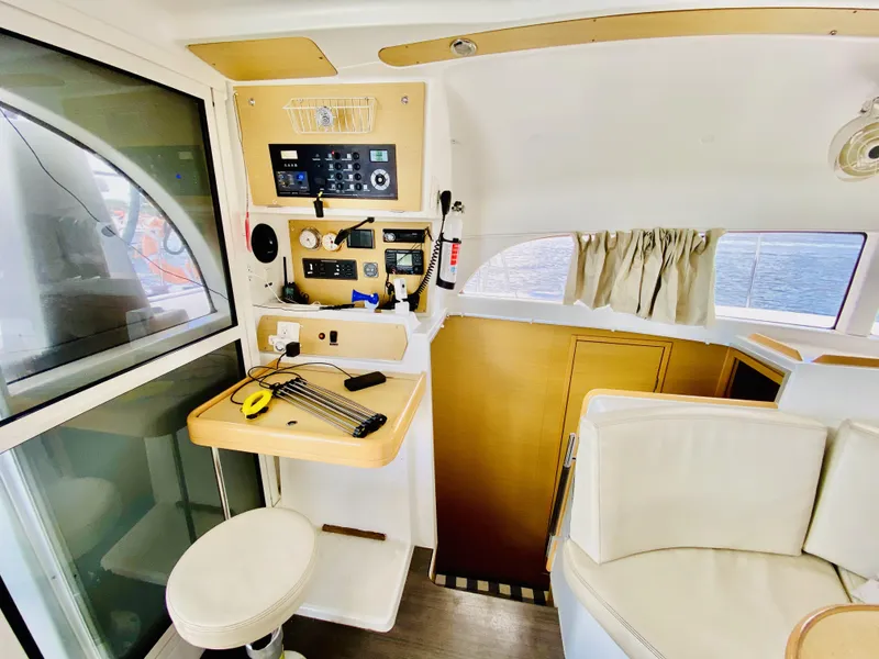 Slide: The Image of Interior of 2014 Lagoon 380 S2 yacht with navigation controls and seating area. - 22