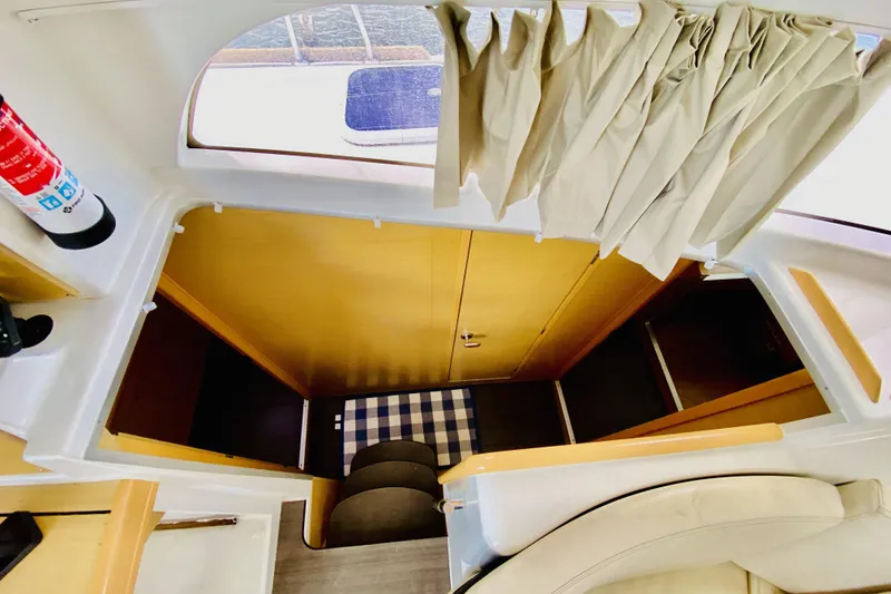 Slide: The Image of Interior view of 2014 Lagoon 380 S2 yacht, featuring stairs and cozy seating area. - 23