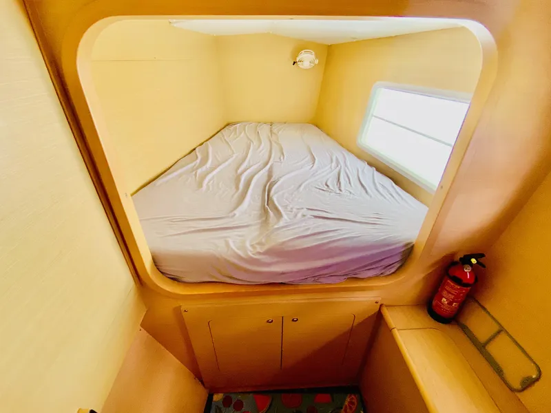 Slide: The Image of Cozy cabin interior of 2014 Lagoon 380 S2 catamaran with bed and fire extinguisher. - 26