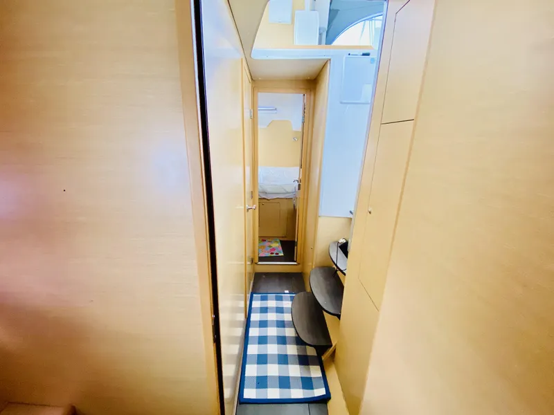 Slide: The Image of Interior of 2014 Lagoon 380 S2 catamaran with wooden finish and checkered rug. - 28