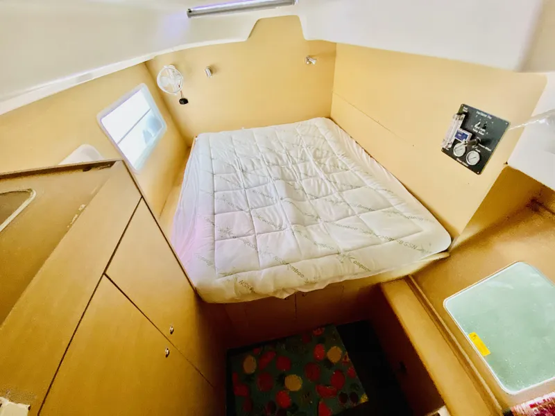 Slide: The Image of Cozy cabin interior of 2014 Lagoon 380 S2 catamaran with bed and storage. - 29