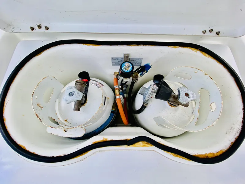 Slide: The Image of Two propane tanks in a storage compartment on a 2014 Lagoon 380 S2 catamaran. - 39