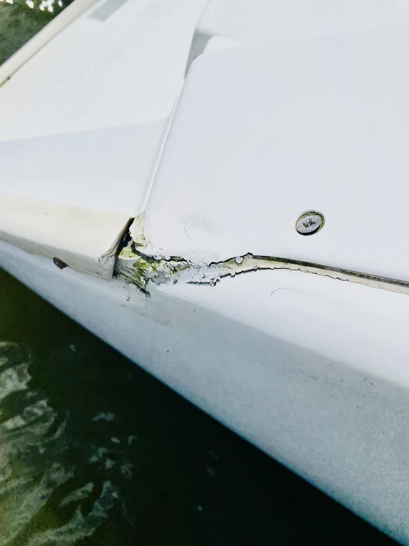 Slide: The Image of Damaged hull of 2014 Lagoon 380 S2 catamaran with visible cracks and wear. - 41