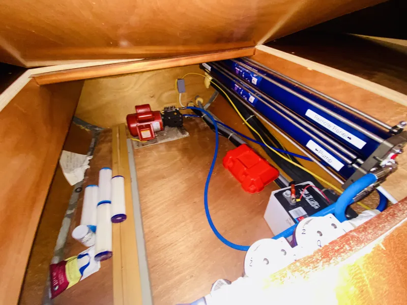 Slide: The Image of Interior view of a 2014 Lagoon 380 S2 yacht's storage compartment with equipment and wiring. - 45