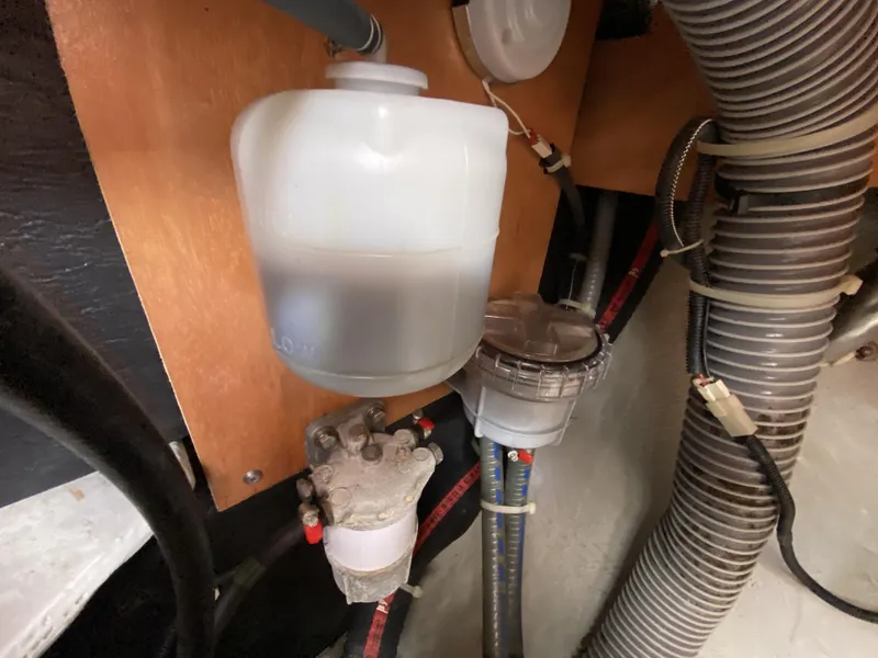 Slide: The Image of Engine compartment of a 2014 Lagoon 380 S2 with fuel filter and hoses. - 46