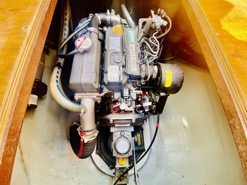Slide: The Image of Engine compartment of a 2014 Lagoon 380 S2 catamaran, showcasing detailed mechanical components. - 49