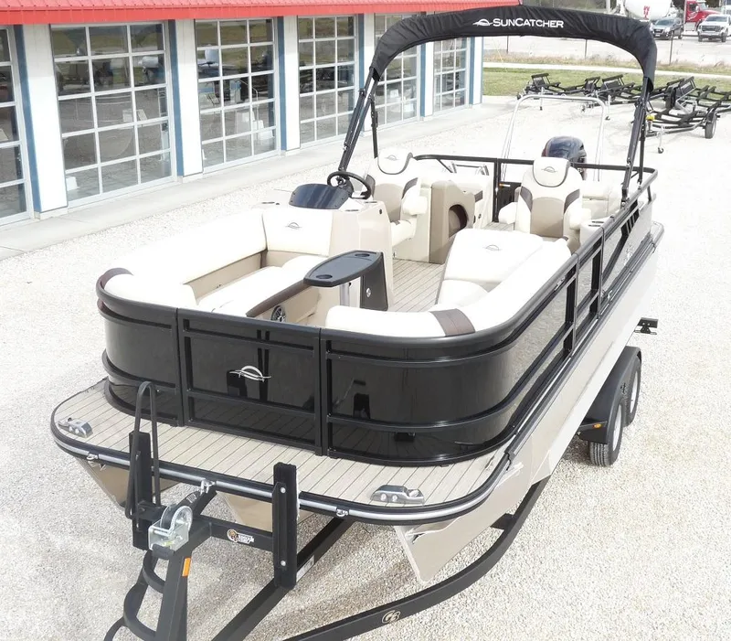 Slide: The Image of 2025 SunCatcher Select 322SS pontoon boat on trailer, featuring spacious seating and sleek design. - 0