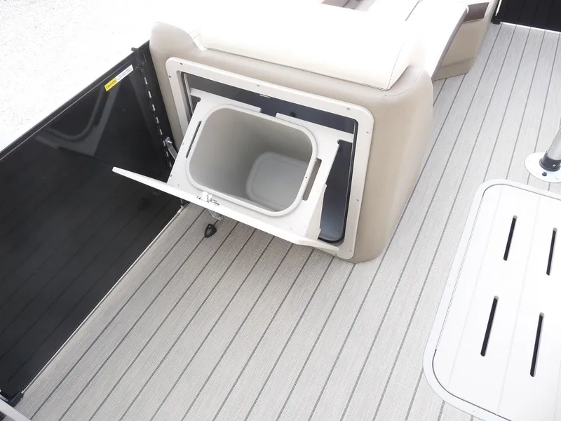 Slide: The Image of 2025 SunCatcher Select 322SS boat interior with built-in storage compartment. - 10
