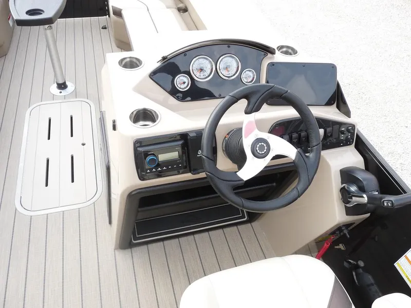 Slide: The Image of 2025 SunCatcher Select 322SS boat dashboard with steering wheel and control panel. - 9