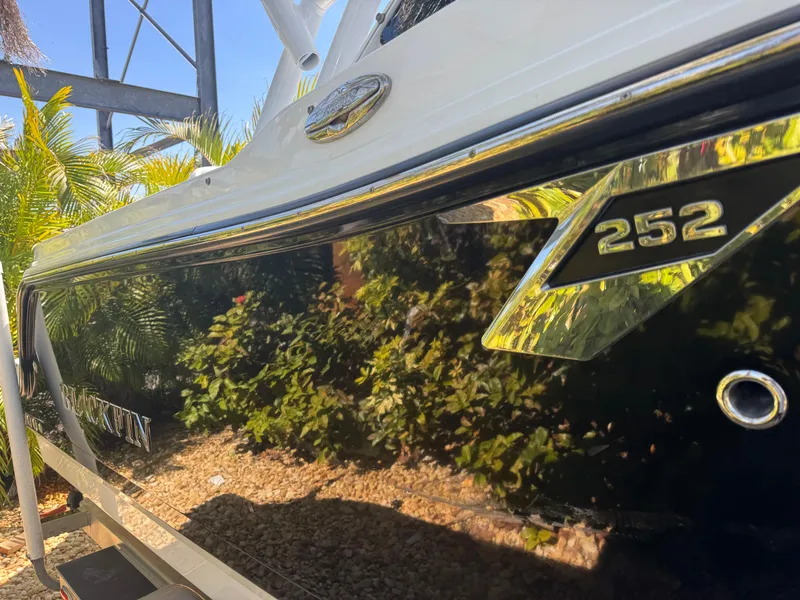 Slide: The Image of 2022 Blackfin 252 DC boat with sleek black exterior and chrome detailing. - 19
