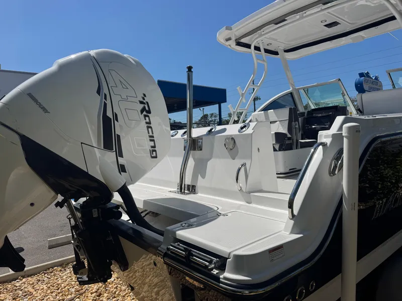 Slide: The Image of 2022 Blackfin 252 DC boat with powerful outboard engine, sleek design, and spacious deck. - 21