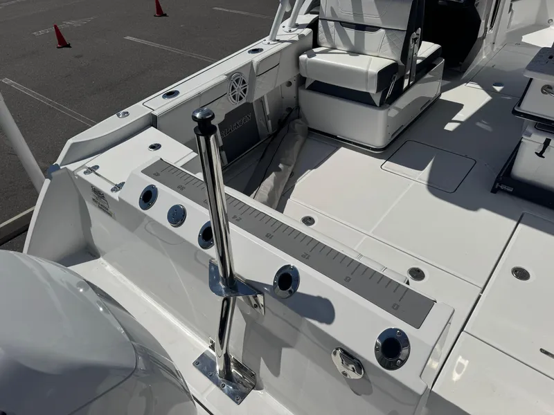 Slide: The Image of 2022 Blackfin 252 DC boat interior with seating and fishing rod holders. - 22