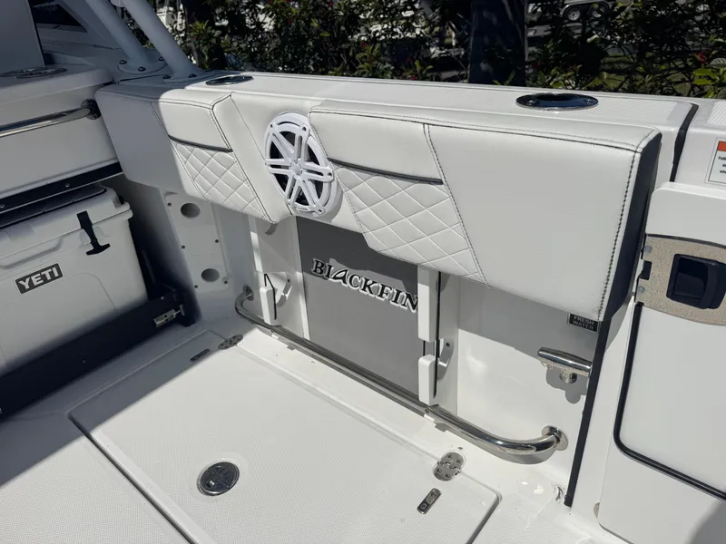 Slide: The Image of 2022 Blackfin 252 DC boat interior with white seating and Yeti cooler. - 27