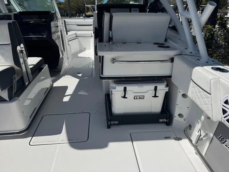 Slide: The Image of 2022 Blackfin 252 DC boat interior with Yeti cooler and seating area. - 28