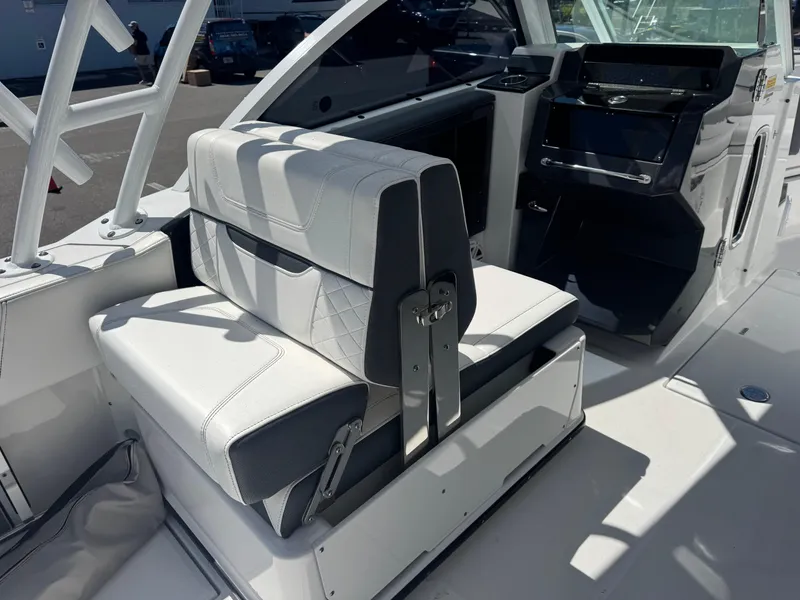 Slide: The Image of 2022 Blackfin 252 DC boat interior with white and gray seating and modern dashboard. - 29