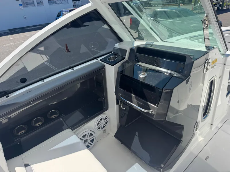 Slide: The Image of 2022 Blackfin 252 DC boat interior with modern dashboard and seating area. - 35
