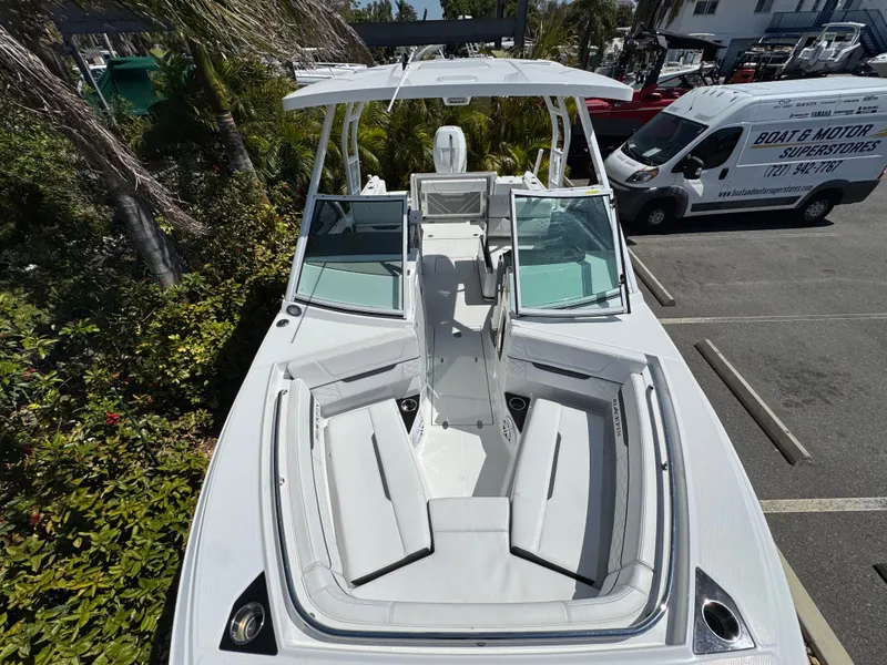 Slide: The Image of 2022 Blackfin 252 DC boat with spacious seating and sleek design, parked outdoors. - 40