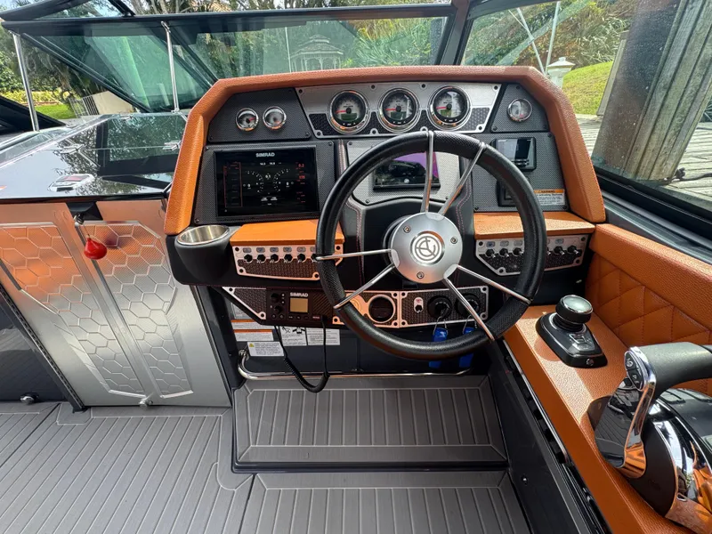 Slide: The Image of 2021 Cruisers Yachts 338 South Beach Edition Bow Rider helm with modern controls and leather accents. - 10