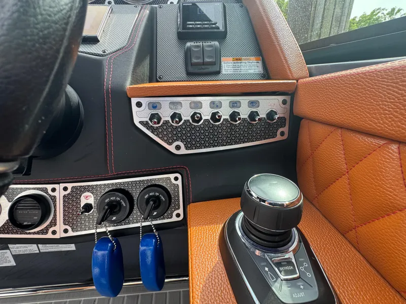Slide: The Image of 2021 Cruisers Yachts 338 South Beach Edition Bow Rider dashboard with controls and joystick. - 11