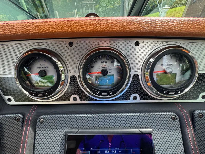 Slide: The Image of Dashboard of 2021 Cruisers Yachts 338 South Beach Edition Bow Rider with gauges and controls. - 12