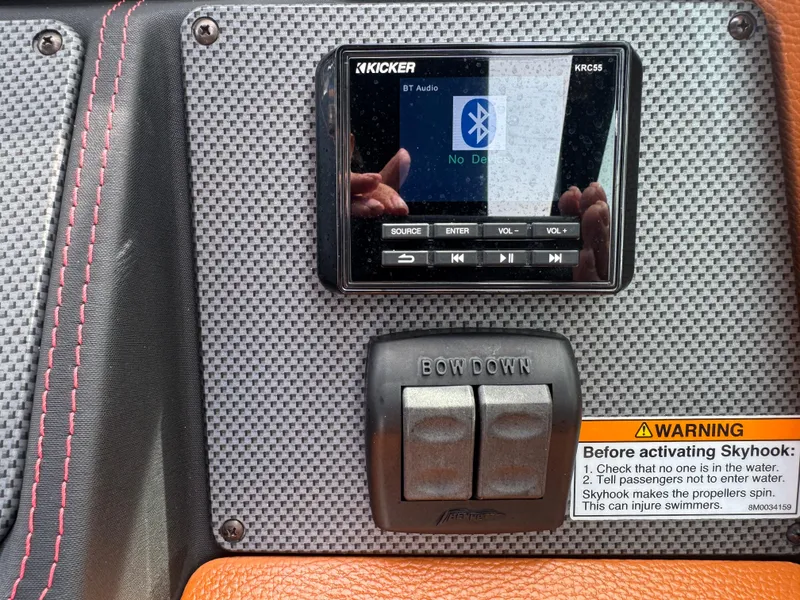 Slide: The Image of 2021 Cruisers Yachts 338 South Beach Edition dashboard with Kicker audio system and Skyhook warning. - 13