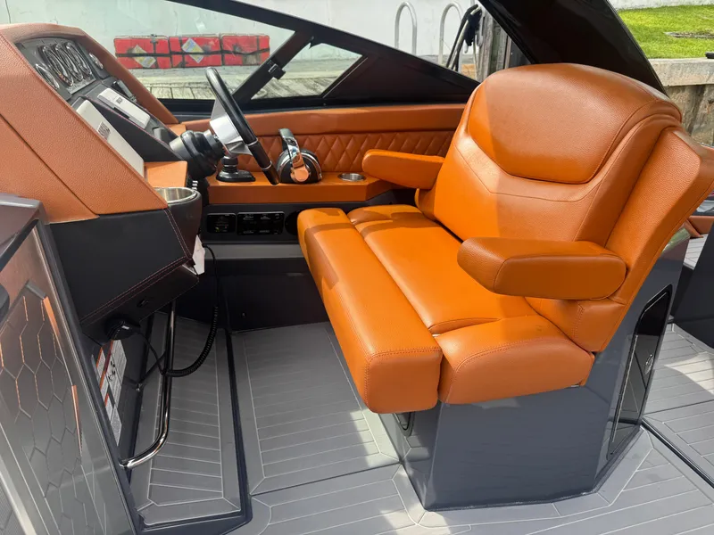 Slide: The Image of 2021 Cruisers Yachts 338 South Beach Edition Bow Rider cockpit with luxurious orange seating. - 16