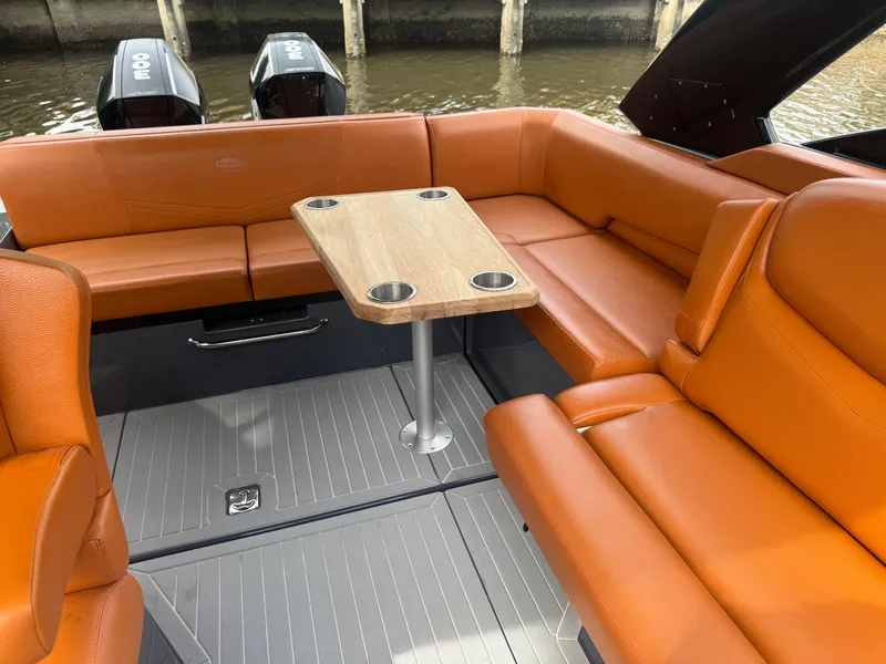 Slide: The Image of 2021 Cruisers Yachts 338 South Beach Edition Bow Rider with orange seating and table. - 19