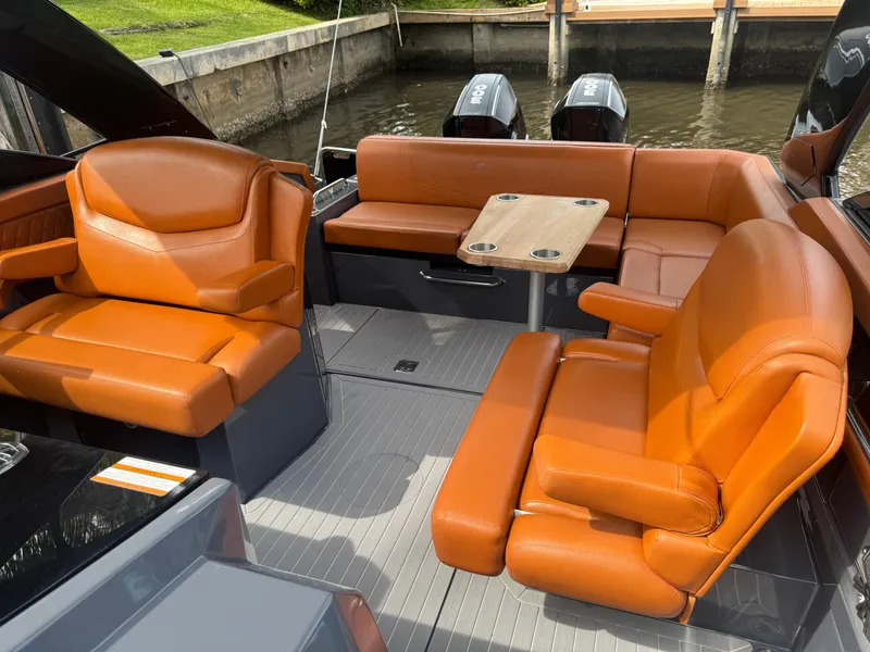 Slide: The Image of 2021 Cruisers Yachts 338 South Beach Edition Bow Rider with luxurious orange seating and table. - 22