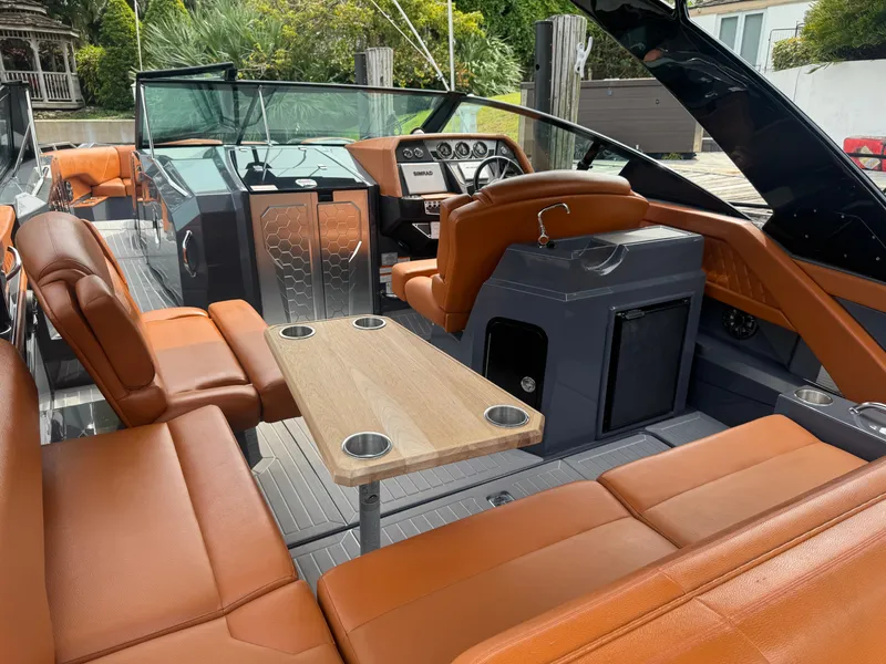 Slide: The Image of 2021 Cruisers Yachts 338 South Beach Edition Bow Rider with luxurious orange seating and sleek design. - 24