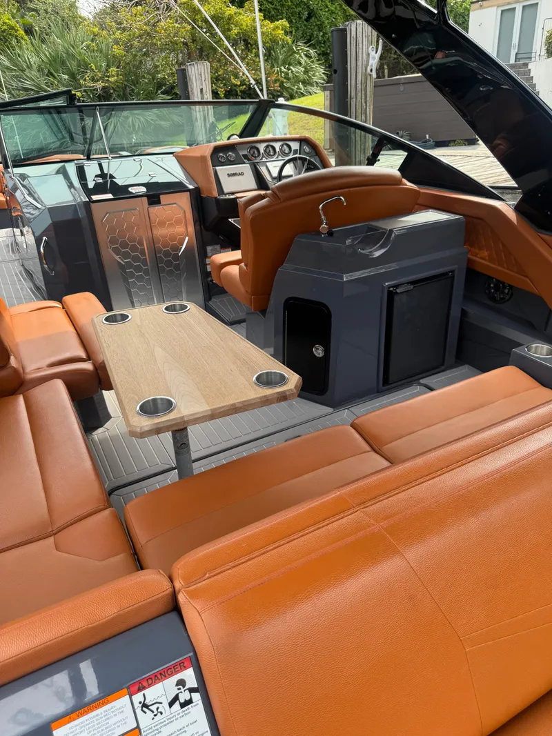 Slide: The Image of 2021 Cruisers Yachts 338 South Beach Edition Bow Rider with orange seating and sleek interior design. - 25